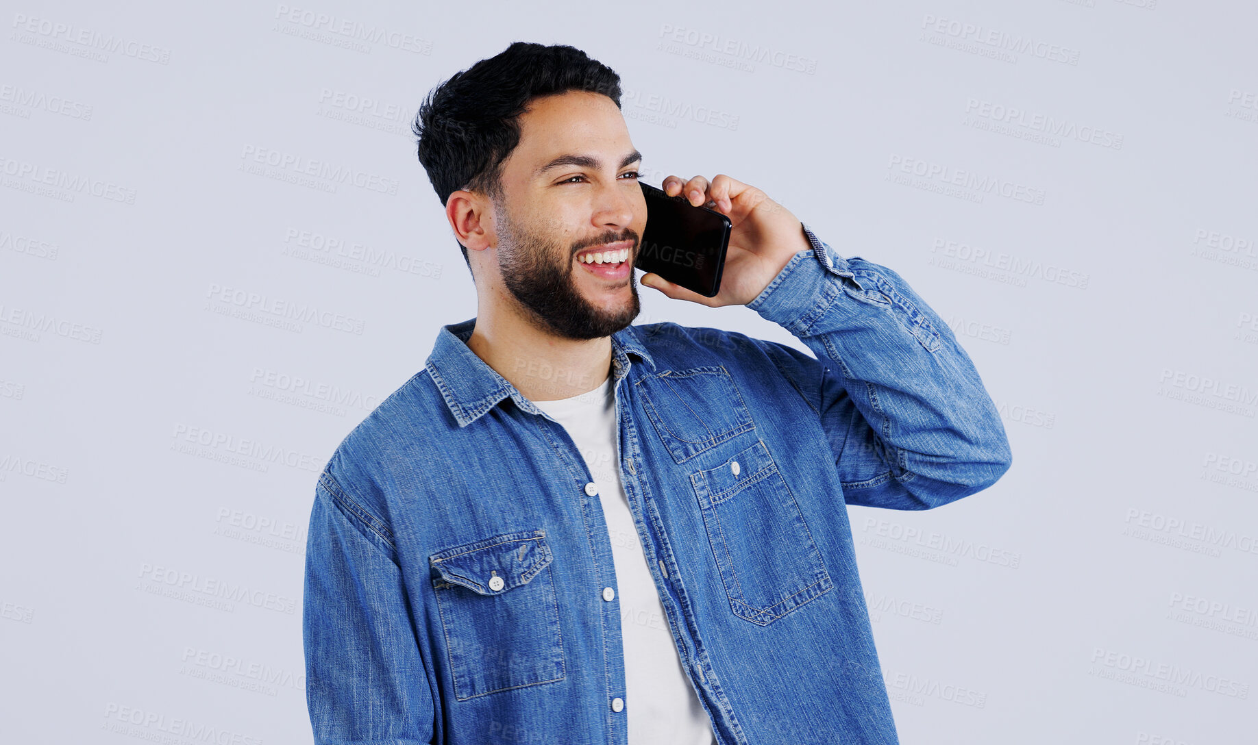 Buy stock photo Man, phone call and communication in studio for contact, networking and funny conversation on white background. Happy young indian model, mobile discussion and laugh for chat, talking and connection 