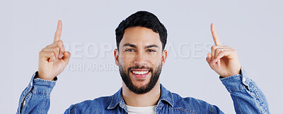 Buy stock photo Happy man, portrait and pointing up on mockup for deal, advertising or marketing against a gray studio background. Face of male person or model showing notification, alert or sale for discount promo