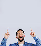 Man, pointing up and offer in studio with hands to promo, announcement or excited for deal in gray background. Mockup, space or person show choice, decision and gesture to information or opportunity