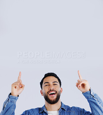 Buy stock photo Man, pointing up and offer in studio with hands to promo, announcement or excited for deal in gray background. Mockup, space or person show choice, decision and gesture to information or opportunity