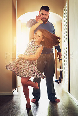 Buy stock photo Shot of an adorable little girl dancing with her father at home