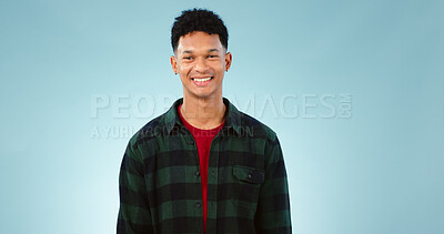 Buy stock photo Portrait, smile and happy man laughing in studio with joke, humor or confidence on blue background. Face, pose and male model with funny, silly or positive attitude, personality or satisfaction