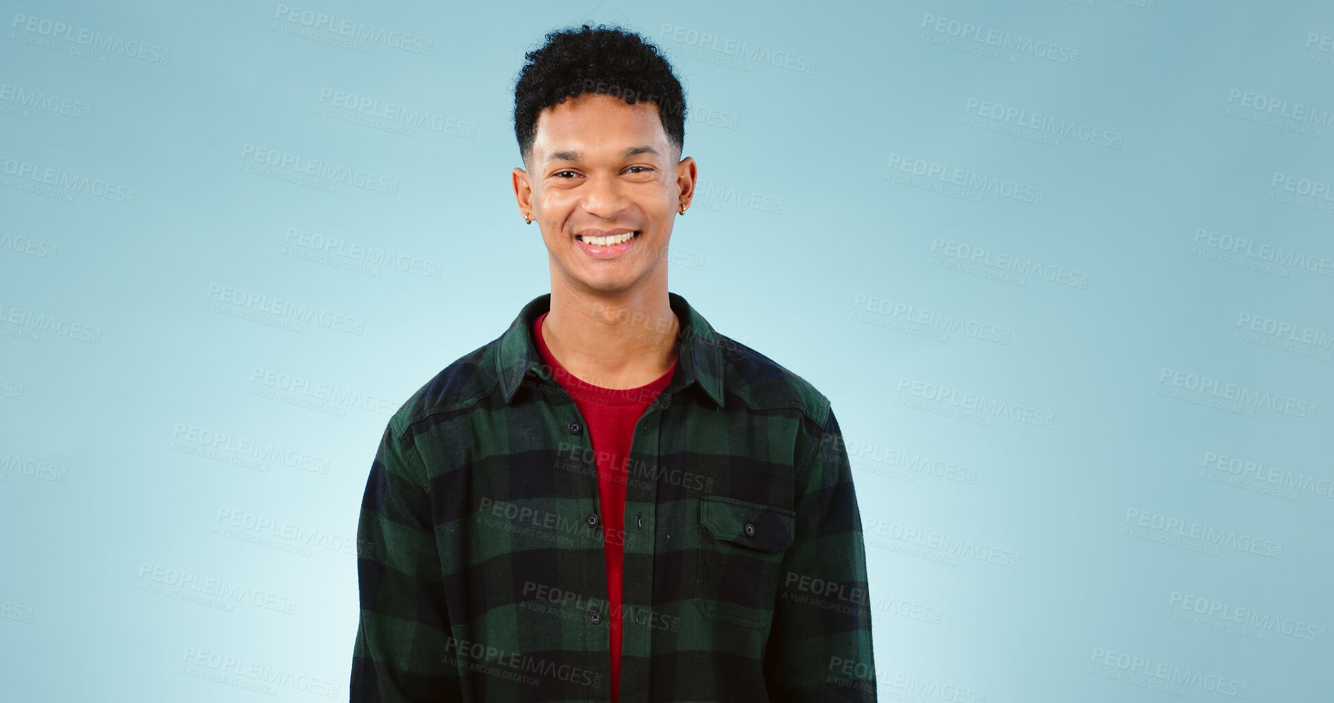 Buy stock photo Portrait, smile and happy man laughing in studio with joke, humor or confidence on blue background. Face, pose and male model with funny, silly or positive attitude, personality or satisfaction