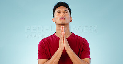 Buy stock photo Religion, praying and young man in a studio for hope, gratitude and spiritual expression. Prayer, christian and male person from Mexico speaking for worship to god isolated by blue background.