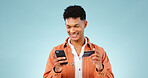 Man, phone and credit card for online shopping, e commerce and digital money on a blue background. Happy student or young person with mobile app, internet banking or e learning registration in studio
