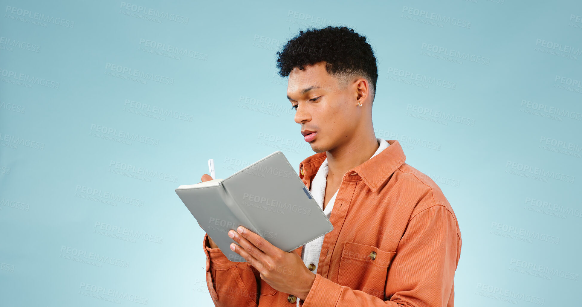 Buy stock photo Thinking, notebook and writing with man, planning and ideas with creativity on a blue studio background. Person, guy and model with problem solving, vision or education with student and knowledge