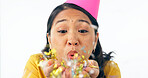 Woman, party hat and blow confetti for birthday celebration, happy and excited in studio mockup. Asian person, smile and festive for winner of prize, giveaway and congratulations by white background 
