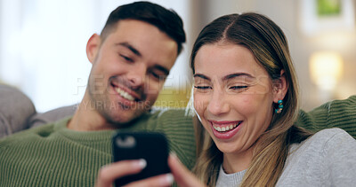 Buy stock photo Laugh, phone and couple on sofa for social media, internet and reading funny website together. Dating, home and happy man and woman on smartphone for meme and bonding, relax and love in living room