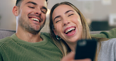 Buy stock photo Laugh, phone and couple on sofa for meme on social media, internet and reading funny website together. Dating, happy and man and woman on smartphone and bonding, relax and love in living room at home