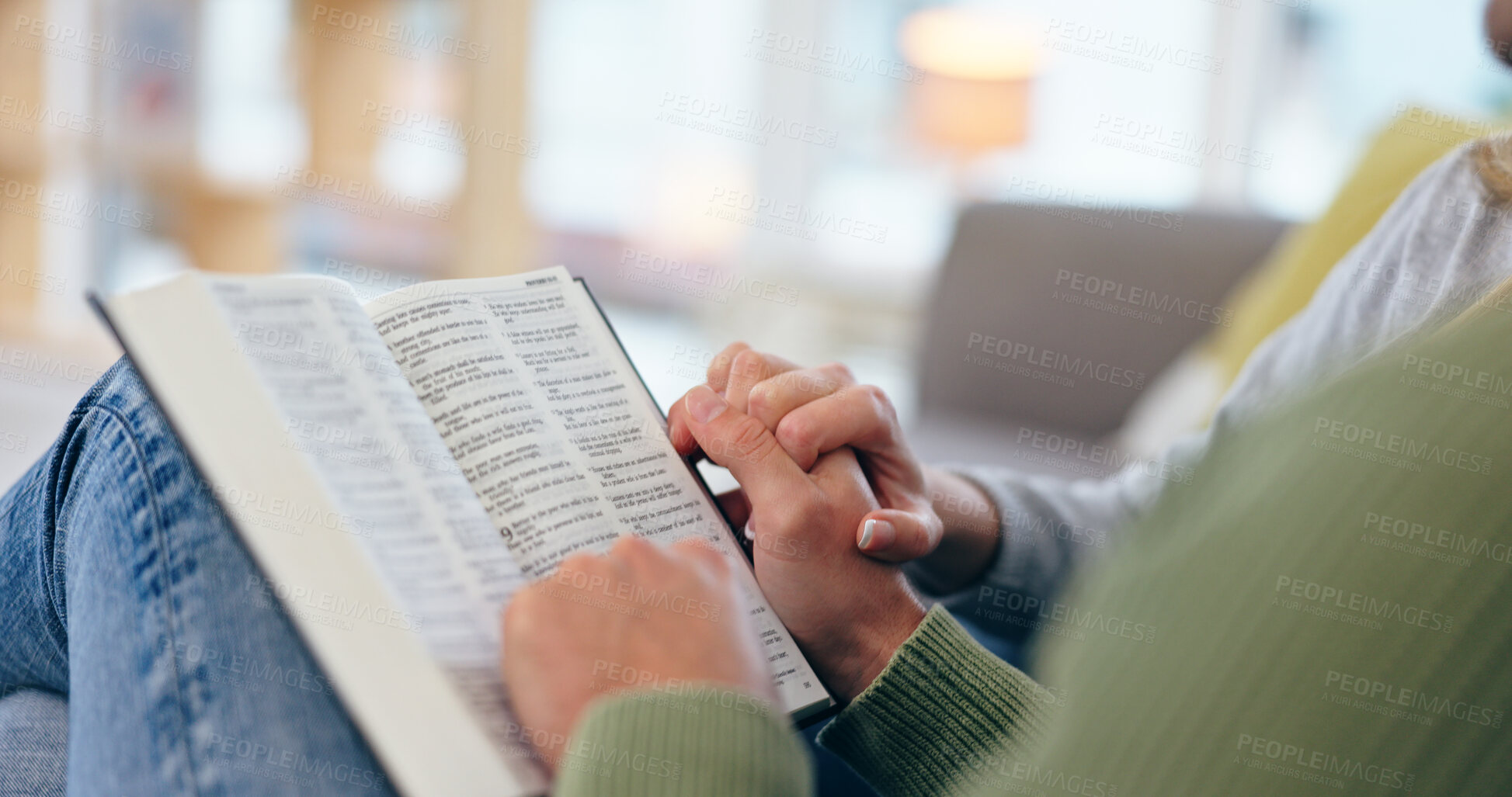 Buy stock photo Couple holding hands, bible and closeup in home for reading with faith, spiritual knowledge and bonding. People, zoom and book for hope, worship or connection to God in living room for peace in house