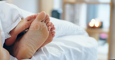 Buy stock photo Feet, love and a couple sleeping in bed together for romance or bonding in their home in the morning. Relax, dating or playful with a man and woman barefoot in the bedroom of their apartment closeup