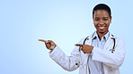 Woman, portrait and pointing for announcement in studio with smile, presentation or advertising space. Black doctor, face and smile for marketing, showing deal or discount with hand and joy on mockup