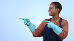 Woman, happy and pointing for presentation in studio with glove, announcement or advertising space. Black person, face and smile for marketing, showing deal or discount with hand and joy on mockup