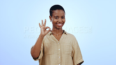 Buy stock photo Black woman, ok sign and studio portrait with smile, vote or icon for review, feedback or choice by blue background. African girl, happy and emoji for opinion, decision and like with perfect symbol