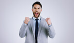 Happy businessman, portrait and fist pump in celebration, winning or achievement against a gray studio background. Excited man employee in prize, good news or business promotion for success on mockup