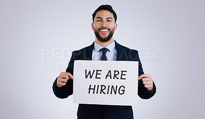 Buy stock photo Happy businessman, portrait and hiring sign for opportunity, advertising or marketing against a gray studio background. Man smile with billboard or poster for recruiting, interview or career position