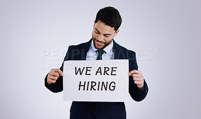 Buy stock photo Happy businessman, job and hiring sign for opportunity, advertising or marketing against a gray studio background. Man smile with billboard or poster for recruiting, interview or career position