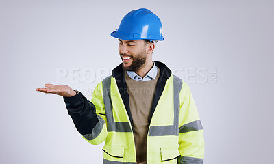 Buy stock photo Happy man, architect and palm for advertising or marketing against a gray studio background. Male person, contractor or engineer smile with hard hat and hand out for deal or service in construction