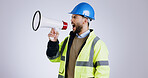 Construction, angry man and megaphone for shouting in studio with mock up on white background in Mexico. Person, engineer or manager with frustrated face for loudspeaker, workplace and instruction