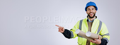 Buy stock photo Portrait, pointing and man engineer with blueprint in studio with mockup space for advertising. Happy, smile and male industrial worker with architect designs and show hand gesture by gray background