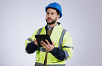 Engineering, man and tablet for inspection, thinking of renovation or project management on a white background. Construction worker for architecture survey, planning and digital technology in studio