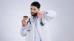 Man, doctor and thumbs down for choice in studio, donut and unhealthy snack in mockup. Mexican person, nutritionist and portrait or no, advice and opinion on diet, fail and food by gray background