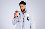 Doctor, diet and choice with donut in hand for nutrition in studio, white background or mockup space. Nutritionist, thinking and man with doubt or decision for health with dessert, sweets or candy