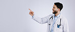 Smile, man and doctor pointing at presentation, show mockup and space on a white background. Happy medical professional gesture at advertising, announcement or information, healthcare and marketing