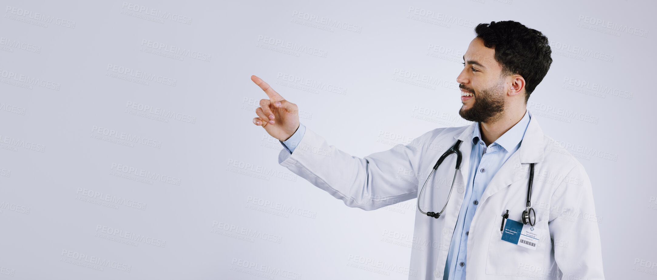 Buy stock photo Smile, man and doctor pointing at presentation, show mockup and space on a white background. Happy medical professional gesture at advertising, announcement or information, healthcare and marketing