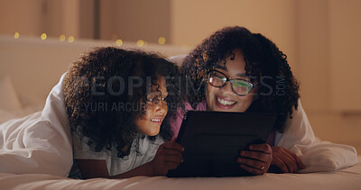 Mom, daughter and tablet at night with internet for movie, cartoon or streaming with blanket on bed in bedroom. Family, woman and girl child with technology in the dark for film, video and bonding