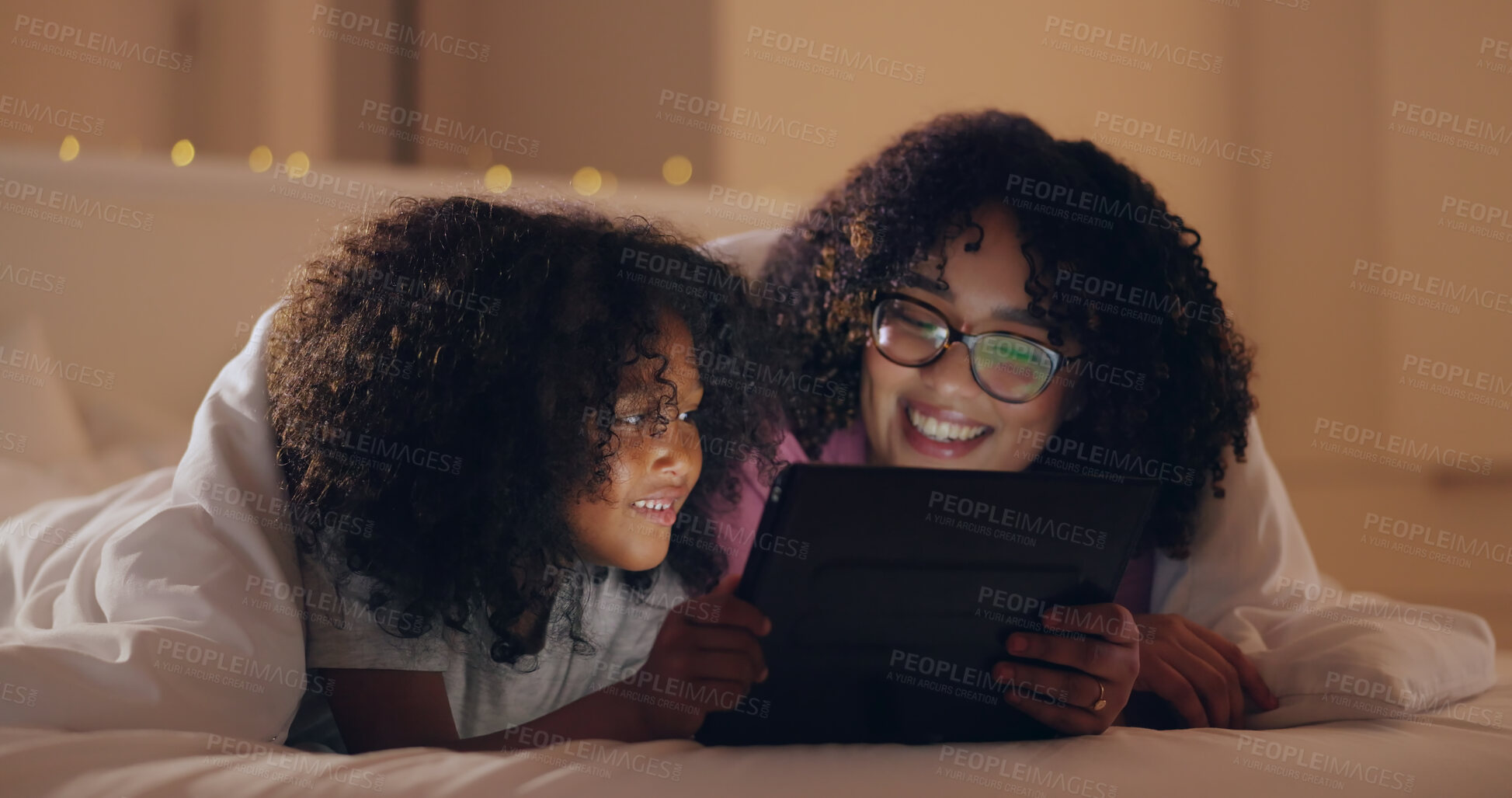 Buy stock photo Mom, daughter and tablet at night with internet for movie, cartoon or streaming with blanket on bed in bedroom. Family, woman and girl child with technology in the dark for film, video and bonding