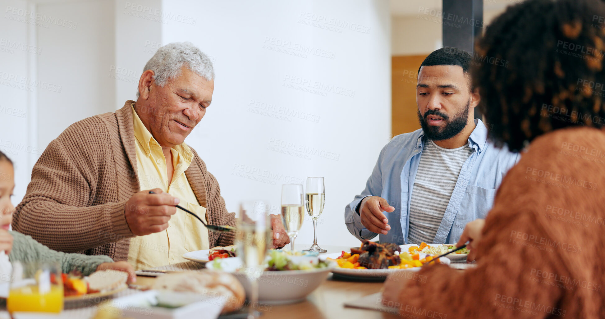 Buy stock photo Love, thanksgiving and a family at the dinner table of their home together for eating a celebration meal. Food, holidays and a group of people in an apartment for festive health, diet or nutrition