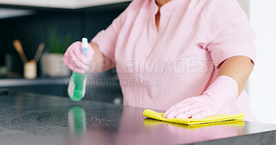 Cleaner woman cleaning kitchen counter with cloth, spray bottle and rubber  gloves in modern home in Stock Photo by YuriArcursPeopleimages