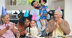 Birthday party, cake and family, children and grandparents with celebration, singing and clapping or applause for love. Happy interracial mom, dad and girl for congratulations and dessert at home