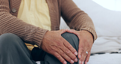 Buy stock photo Hands, knee pain and senior man on a sofa with arthritis, fibromyalgia or osteoporosis closeup. Legs, problem and zoom of elderly person with massage for relief from inflammation, injury or joint