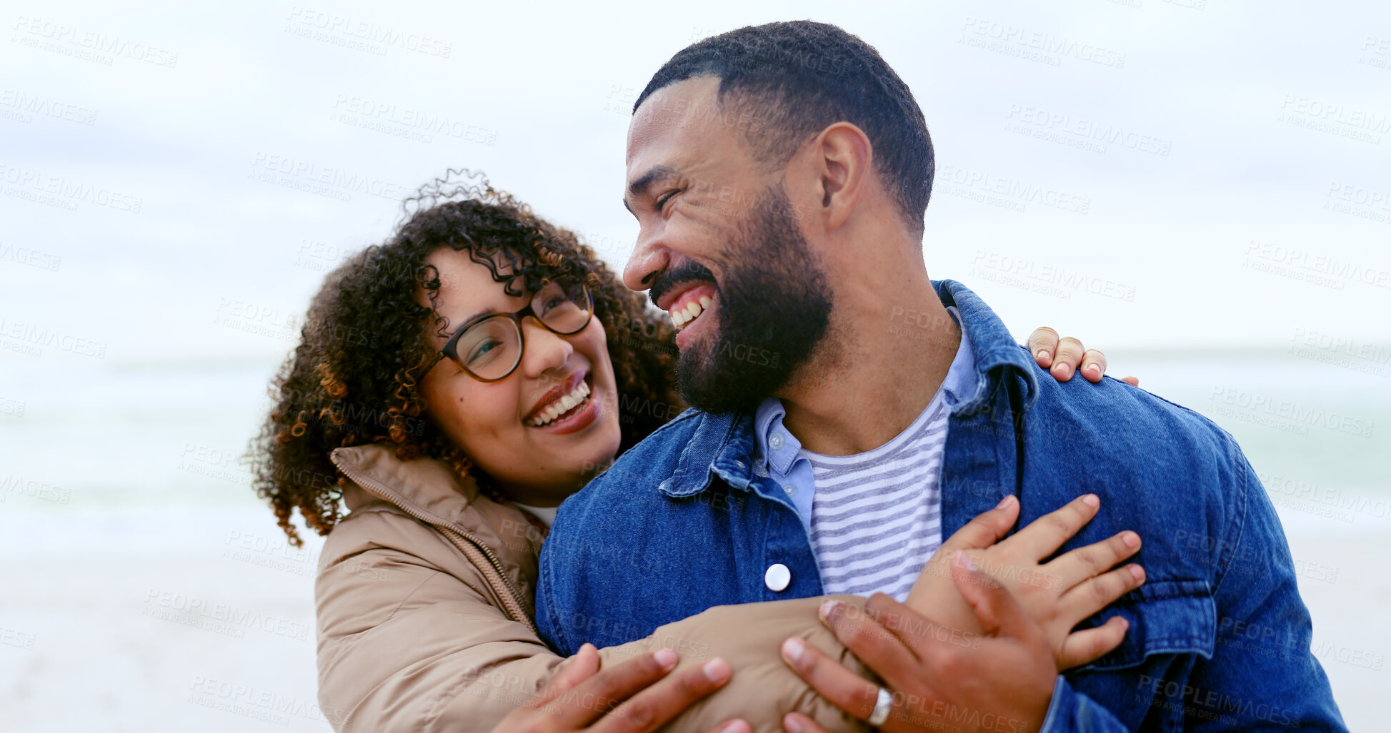 Buy stock photo Happy couple, laughing or hug by beach in nature, care support for relax on weekend adventure. Young man, woman or smile face for bond in marriage, love or cape town for leisure in health wellness