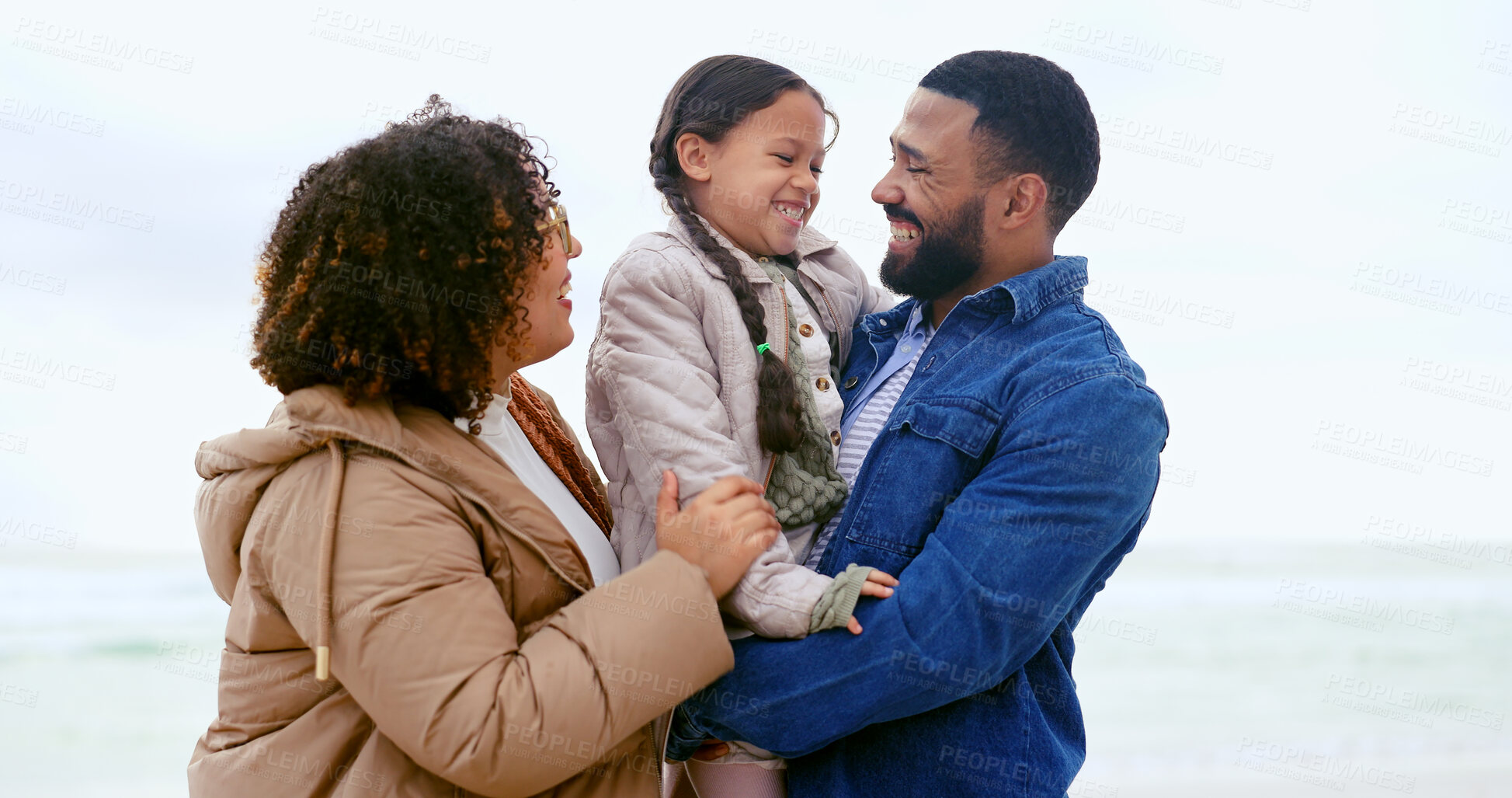 Buy stock photo Happy family, hug child and love by beach, nature or support  to relax on calm holiday. Young man, woman and daughter with bonding for care, marriage and vacation in rio de janeiro for peace wellness