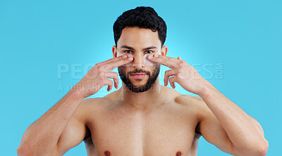 Buy stock photo Skincare, portrait and man with eye patches for anti ageing treatment isolated on blue background. Care, skin and face of model with collagen mask on eyes, dermatology and luxury spa facial in studio