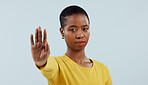 Black woman, portrait and hand in stop for protest, rejection or no isolated against a gray studio background. Face of serious African female person or model with gesture for halt or refuse on mockup