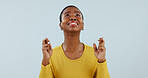 Hope, wish and black woman in studio with fingers crossed for opportunity, deal or good news prayer. Praying hands, thinking and person with winning dream, confidence and faith on white background.