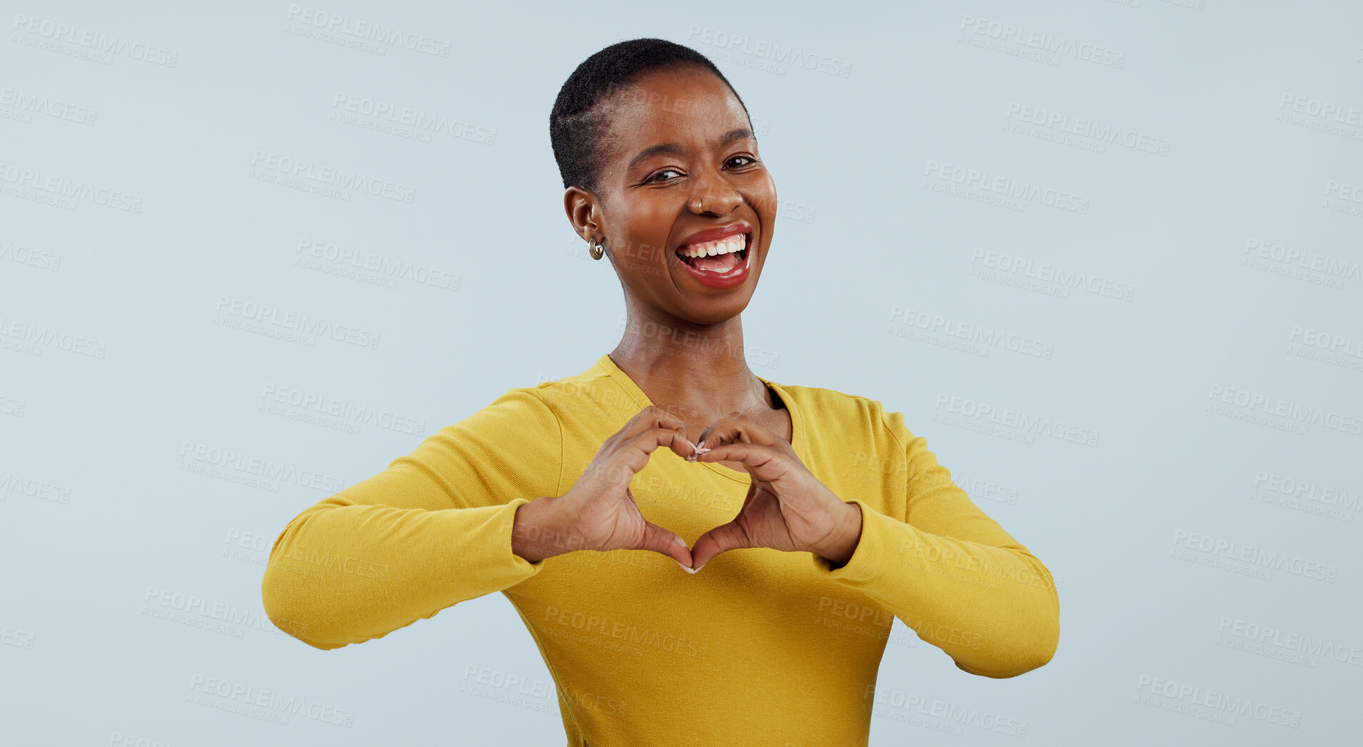 Buy stock photo Happy black woman, portrait and heart hands for love, care or romance against a gray studio background. Face of African female person or model showing like emoji, shape or romantic gesture on mockup