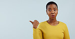 Surprise, news and portrait of black woman with hand pointing in studio for wow announcement on grey background. Emoji, face and African model show unexpected results, giveaway or secret promotion