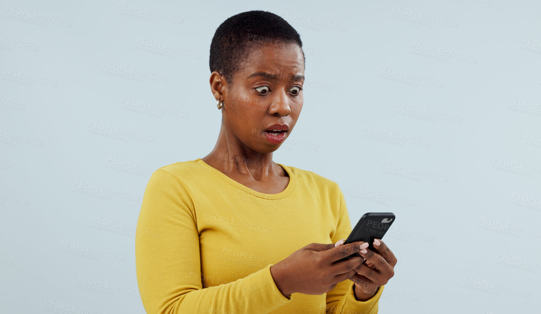 Buy stock photo Black woman, phone and shocking news on social media, terrifying or online against a studio background. Face of surprised African female person or model on mobile smartphone for alert notification