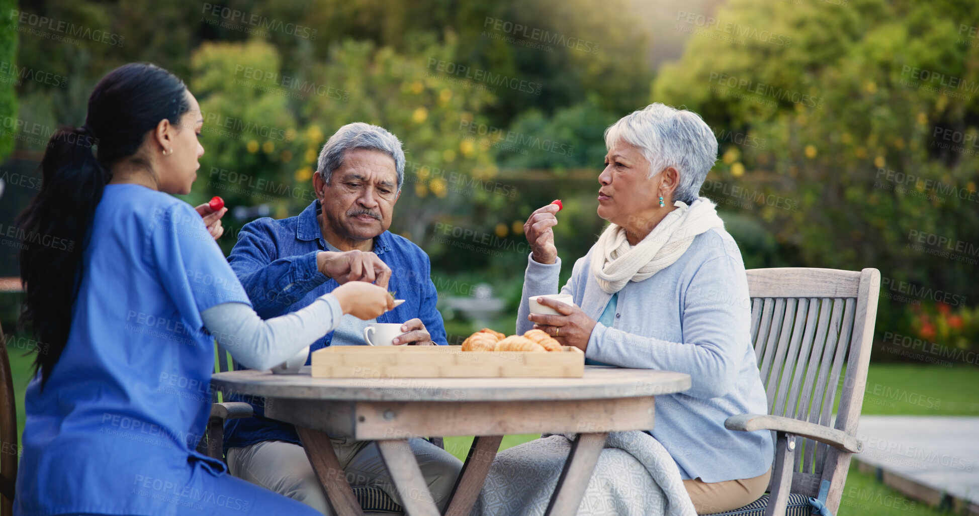 Buy stock photo Nurse, eating or breakfast for elderly care, retirement or healthcare support at park or nature. Caregiver, senior man or old woman with tea, meal or outdoor snack together in health and wellness