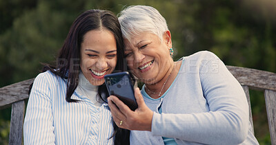 Buy stock photo Senior, mother and woman with smartphone on bench, nature and laughing for social media meme on retirement. Mature parent, older daughter and technology in park for online comedy and love in garden