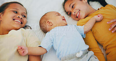 Buy stock photo Love, family and sisters with baby boy on a bed for bonding, relax and conversation at home together. Happy, care and girl children lying with little brother in a bedroom with comfort and security