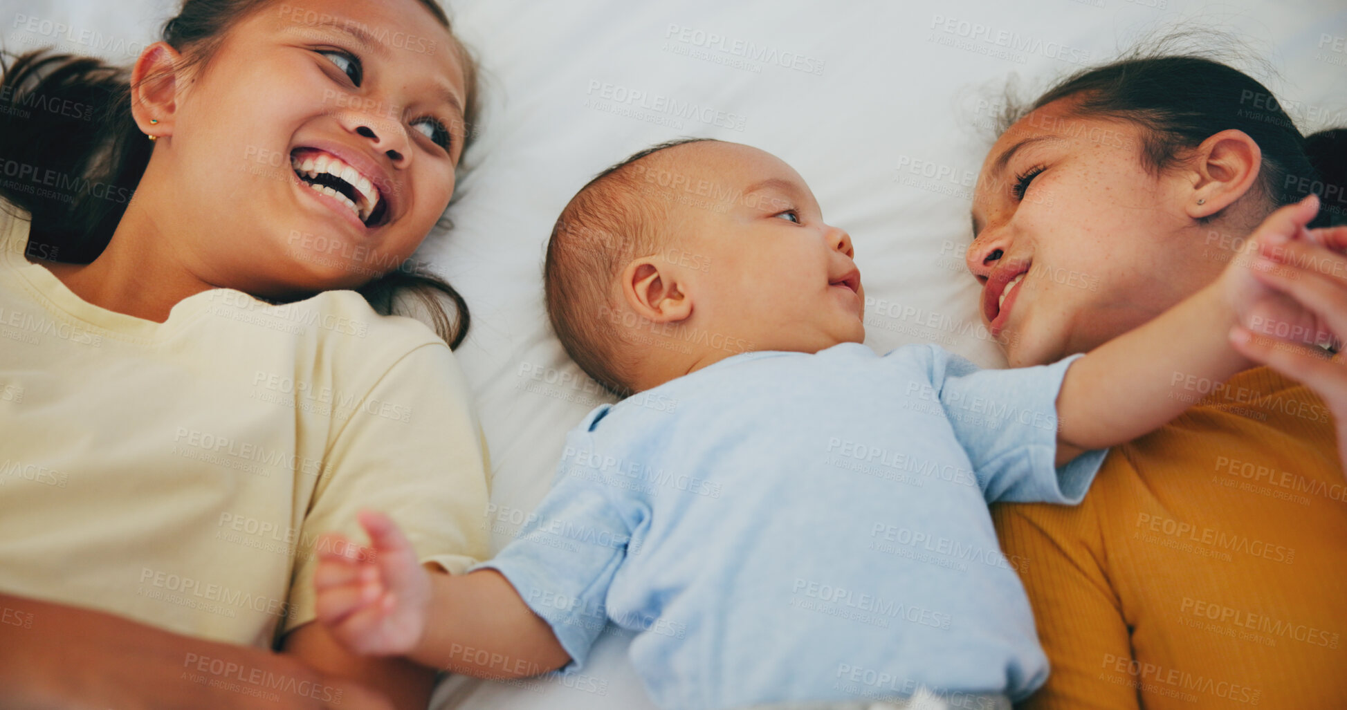 Buy stock photo Happy family, love and sisters with baby on a bed for bonding, relax or conversation at home together. Smile, newborn or girl children lying with newborn boy in bedroom with comfort, security or care