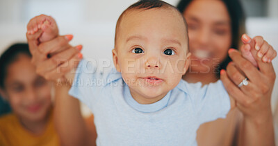 Buy stock photo Portrait, baby and holding hands with a family in the living room of their home together for bonding. Face, cute or adorable with an infant boy, his mother and sister in their apartment closeup