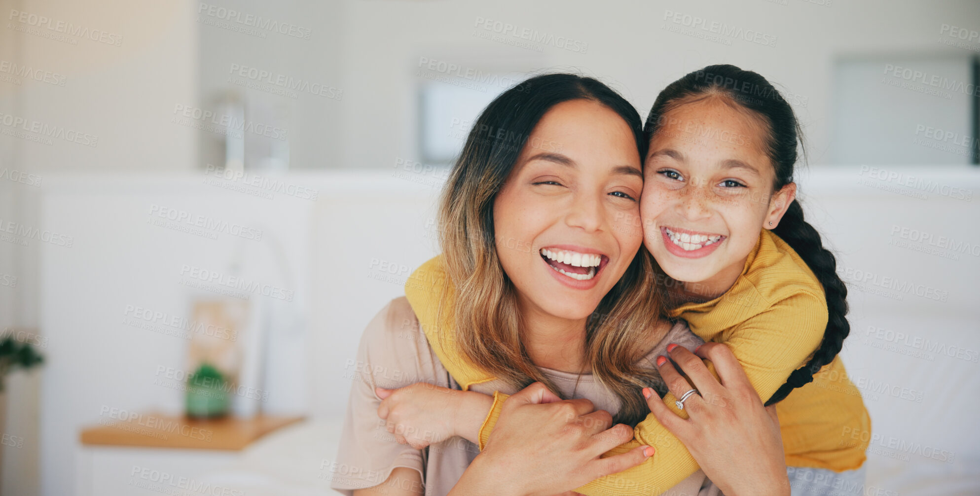 Buy stock photo Portrait, family and a woman hugging her daughter in the bedroom of their home in the morning together. Face, love and smile with a young girl embracing her mother while on a bed in their apartment