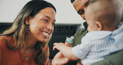 Buy stock photo Family, smile and play or pacifier for love and bonding or fun, relax and support or laughing at home. Happy parents and baby, connect and humor or funny, joy and relaxed or silly, goofy and dummy